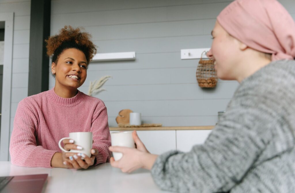 Two women sharing coffee and conversation at home