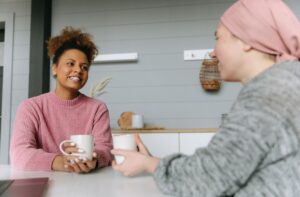 Two women sharing coffee and conversation at home