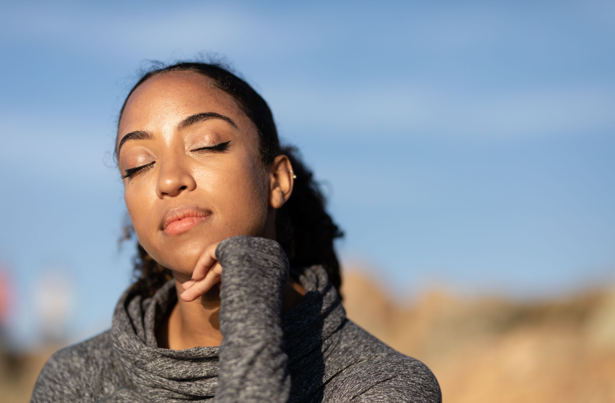 Woman with eyes closed relaxing in the sunlight